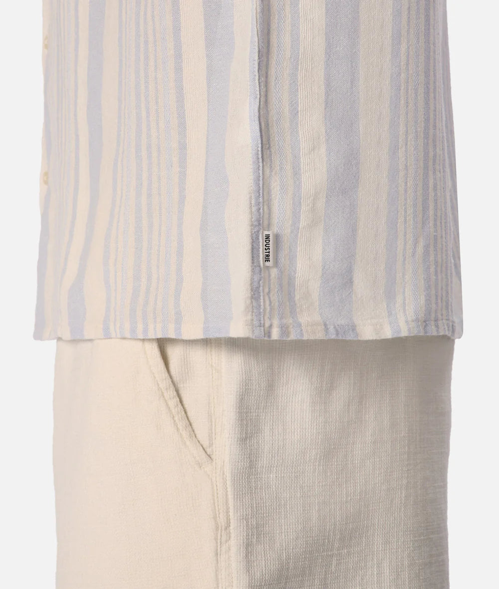 Striped shirt and beige pants on a white background