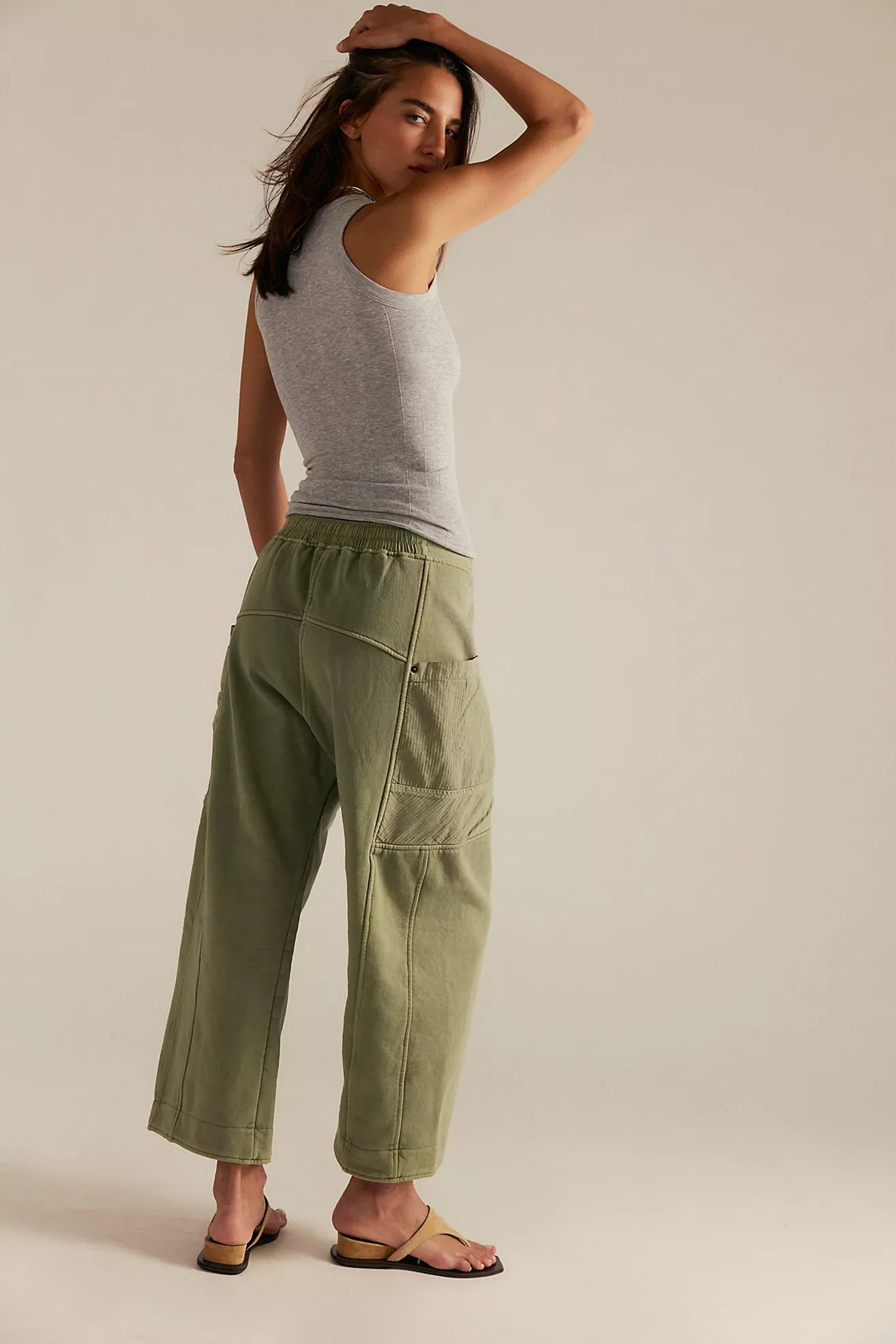 A woman wearing green utility-inspired pants by Free People.