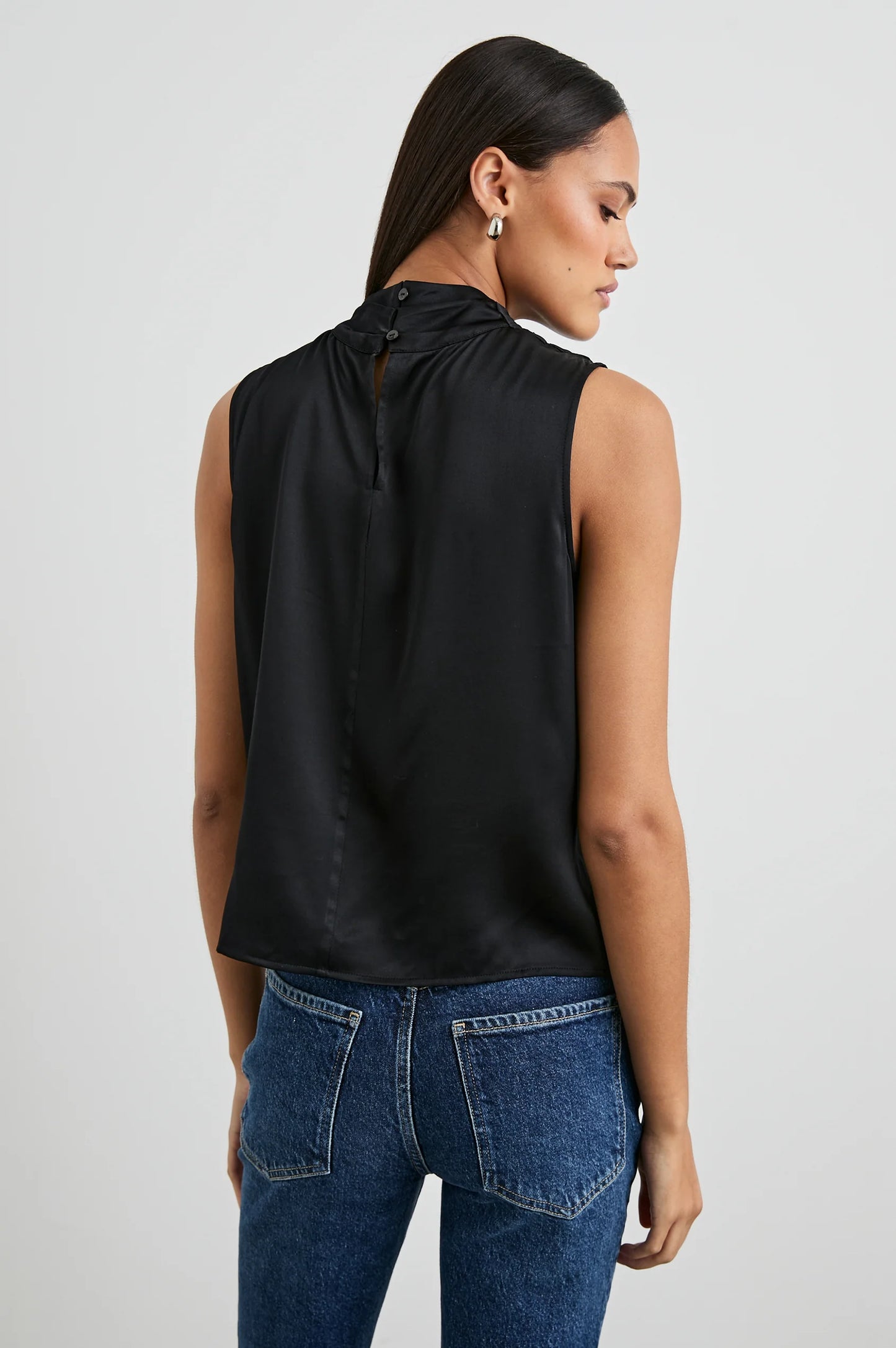 This sleeveless mock neck top offers back neckline button closure