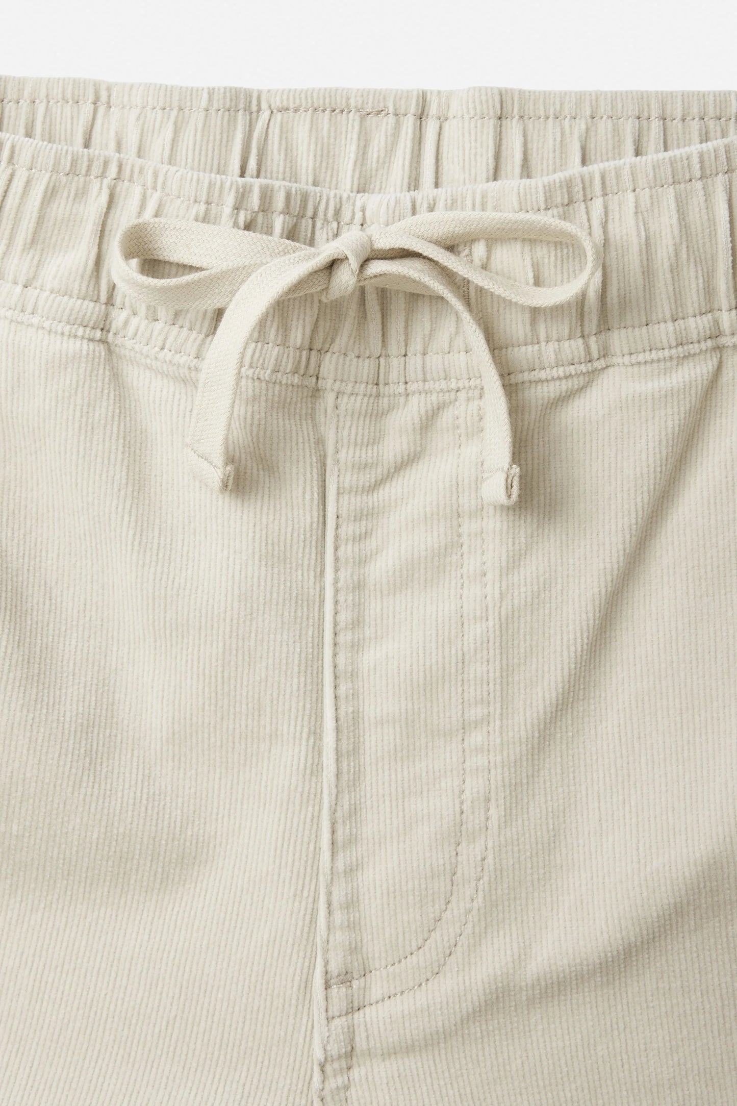 Men's off-white corduroy pants with adjustable waist and drawstring tie closure