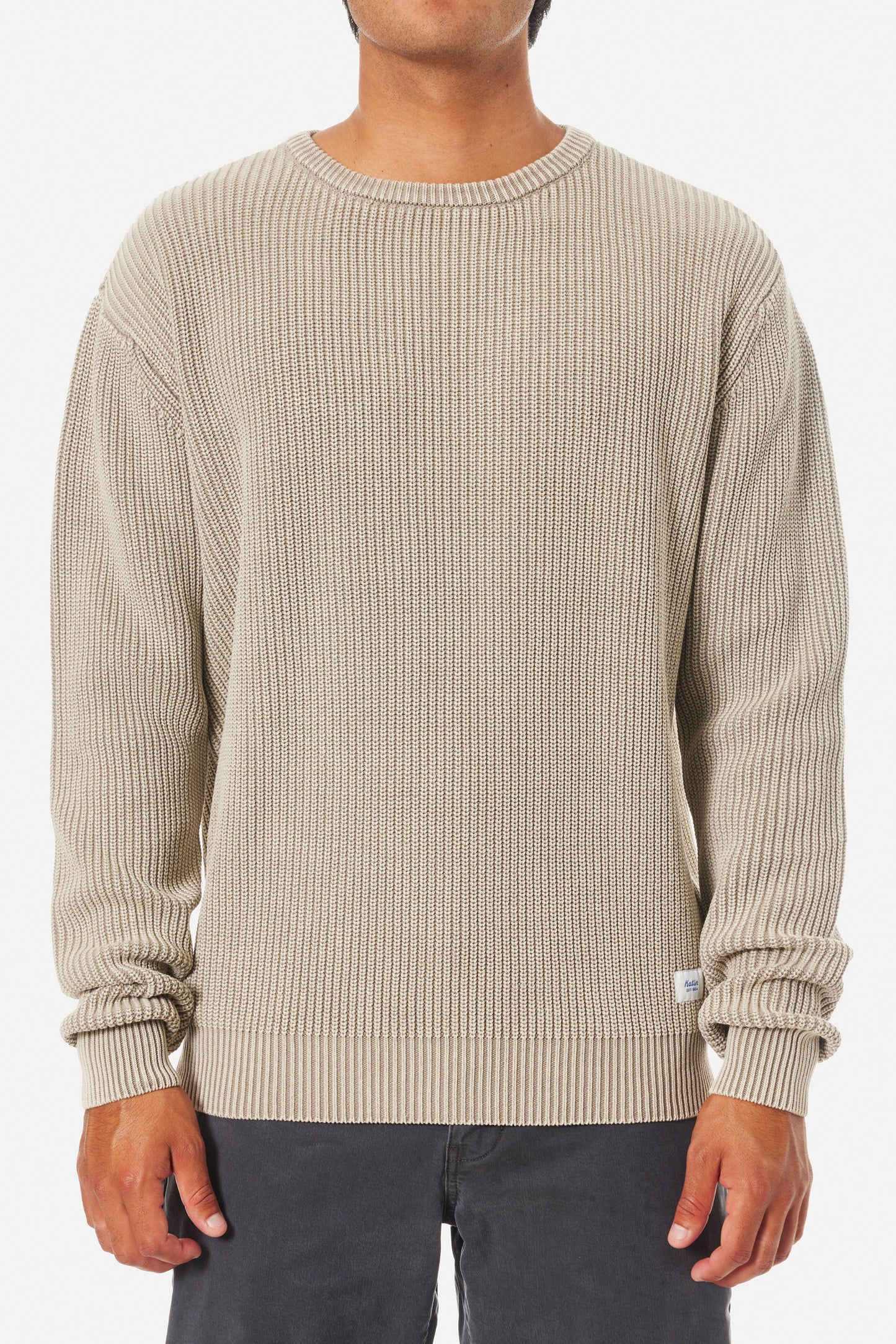 Man wearing a beige knit crewneck sweater from Katin