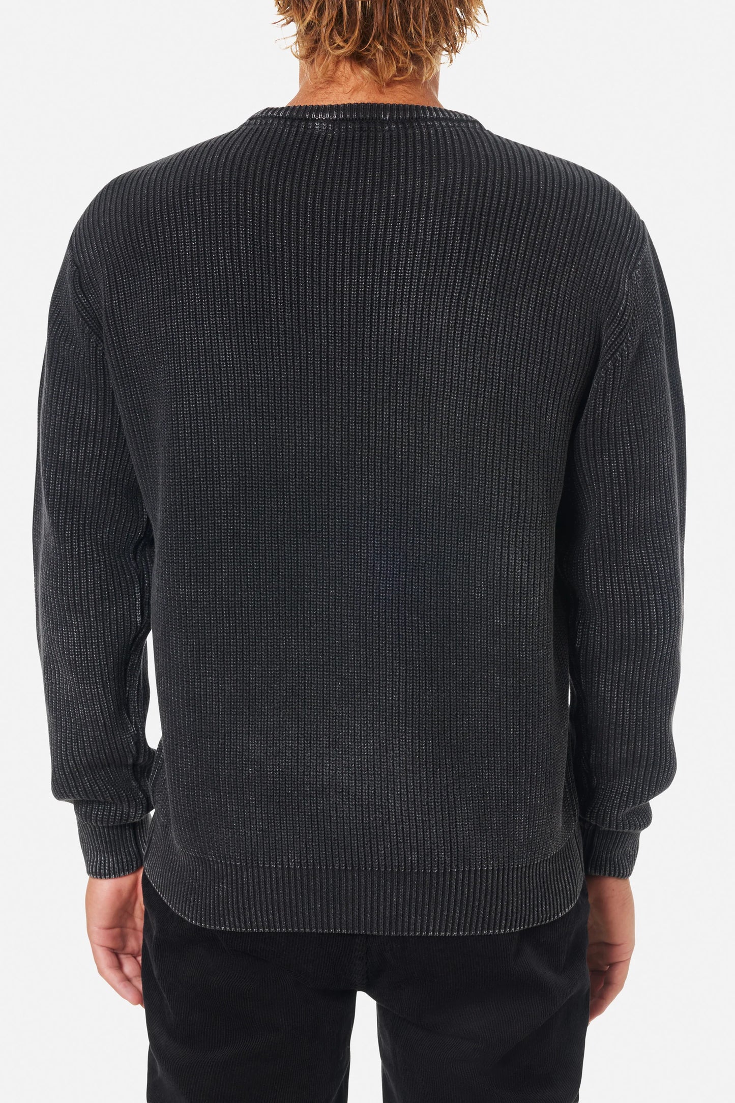Man wearing the black wash Swell Sweater by Katin