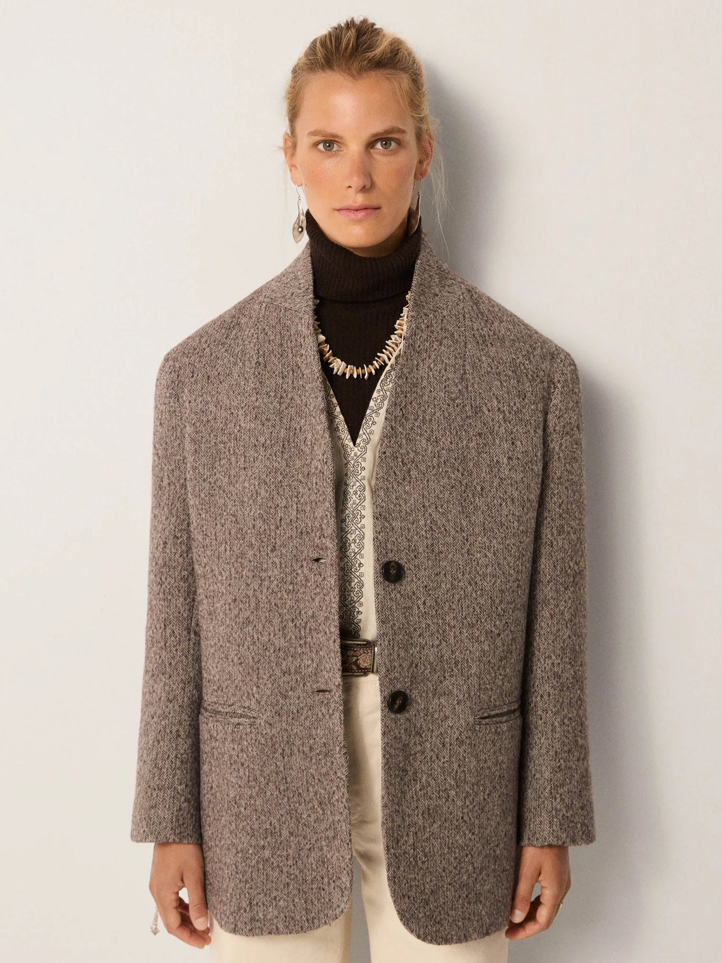 Person wearing a brown textured blazer coat