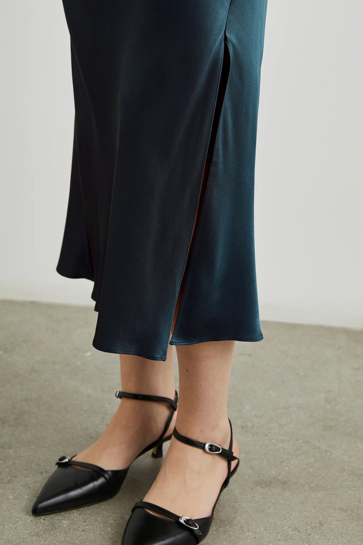 Skirt slit detail on the Maya Midi Slip Skirt from Rails in the color Deep Sea