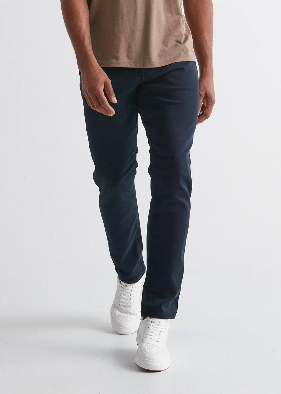 Front view of man wearing the No Sweat Relaxed Taper pant by DUER in color Navy