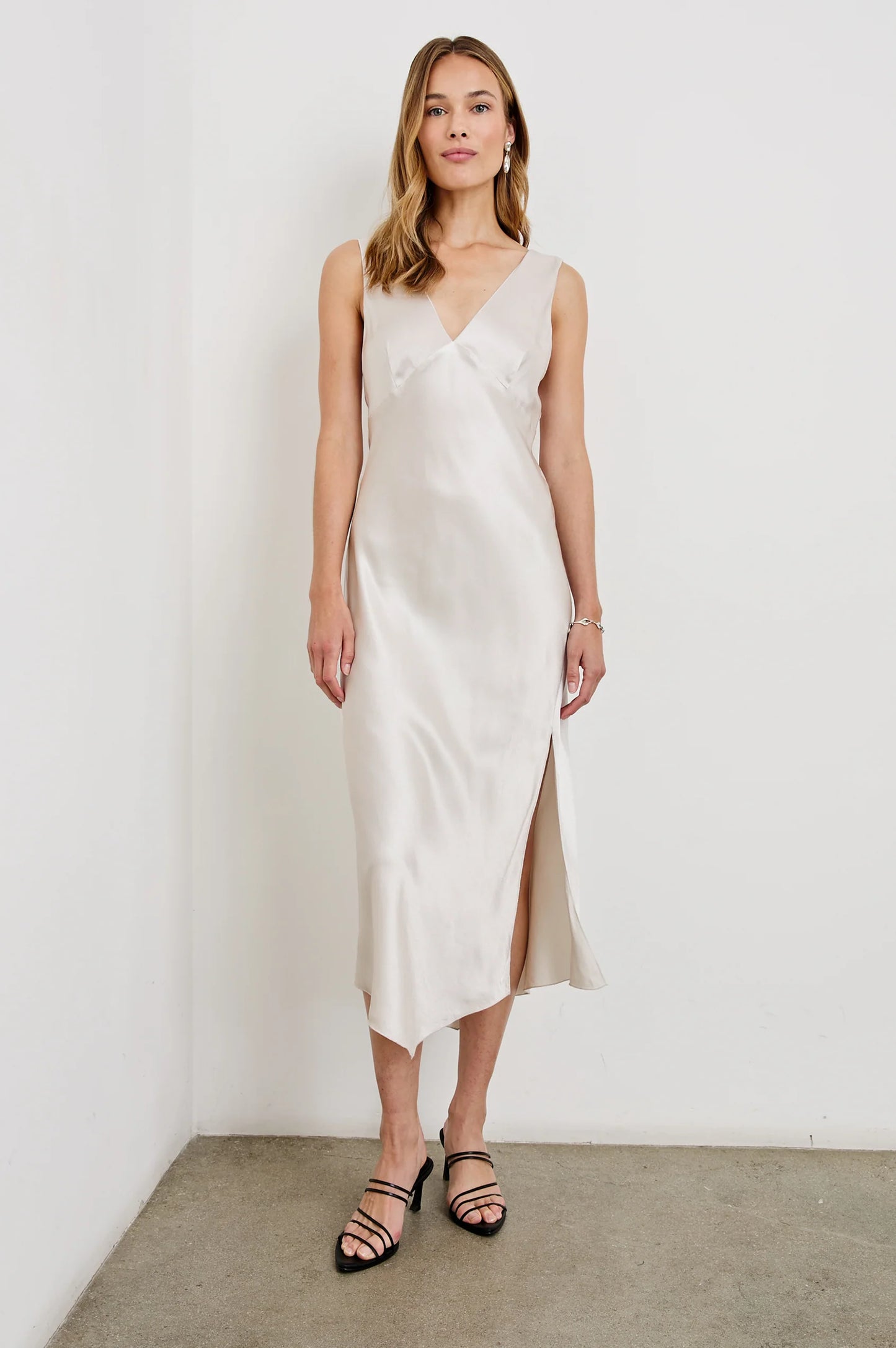 A woman wearing the Ivory Monique Midi Slip Dress by Rails