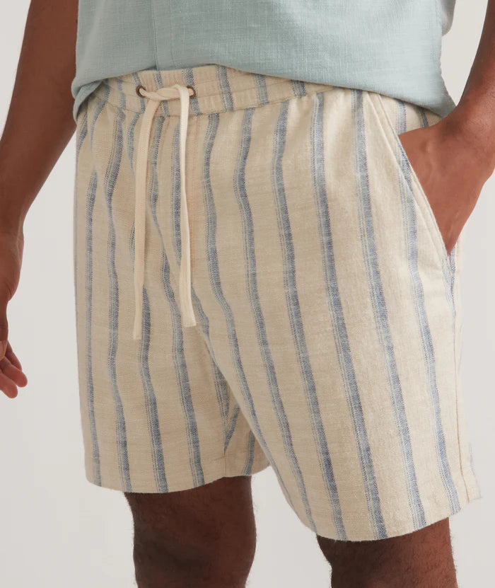 Front detail view of the Marine Layer 6" Saturday Selvage Beach Short in the color Natural/Blue Stripe