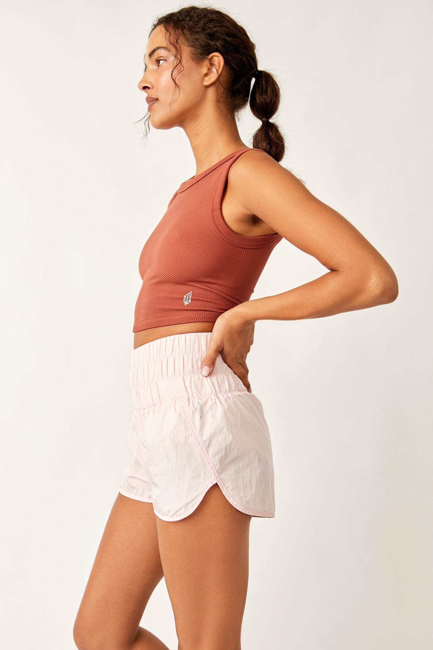 Side view of the Free People Free Throw Muscle Tank in the color Sequoia