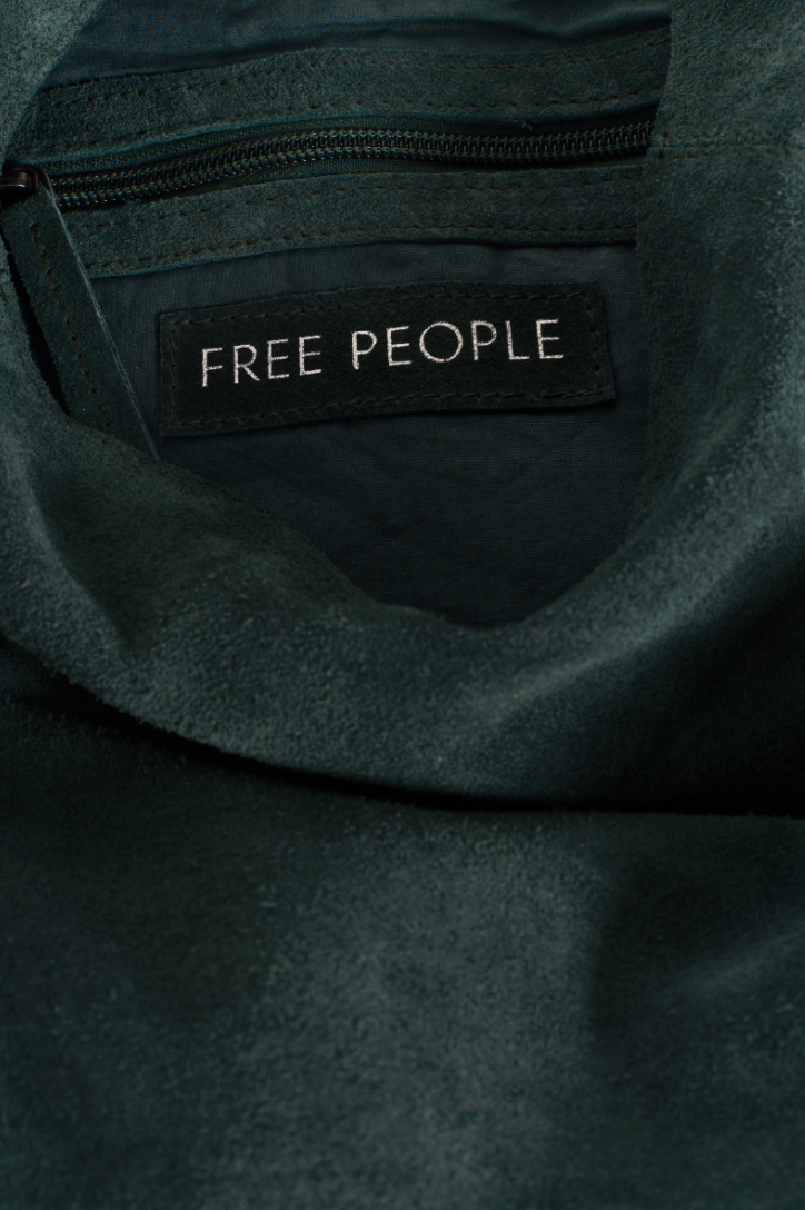 Dark green tote bag with 'Free People' label