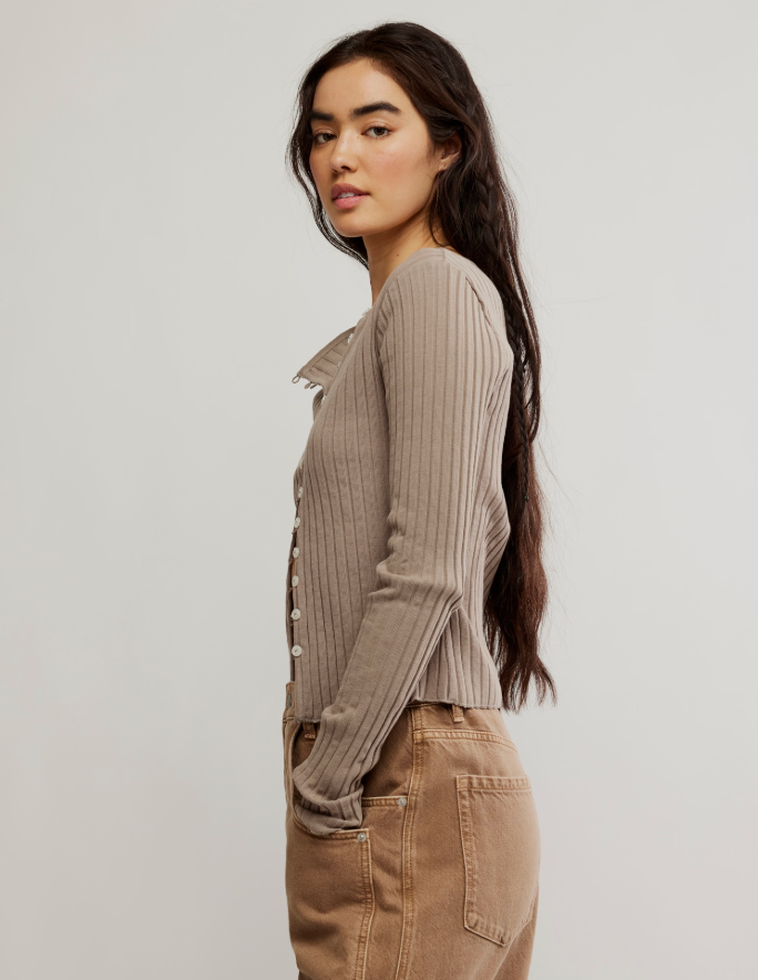 Woman wearing a ribbed sweater by Free People