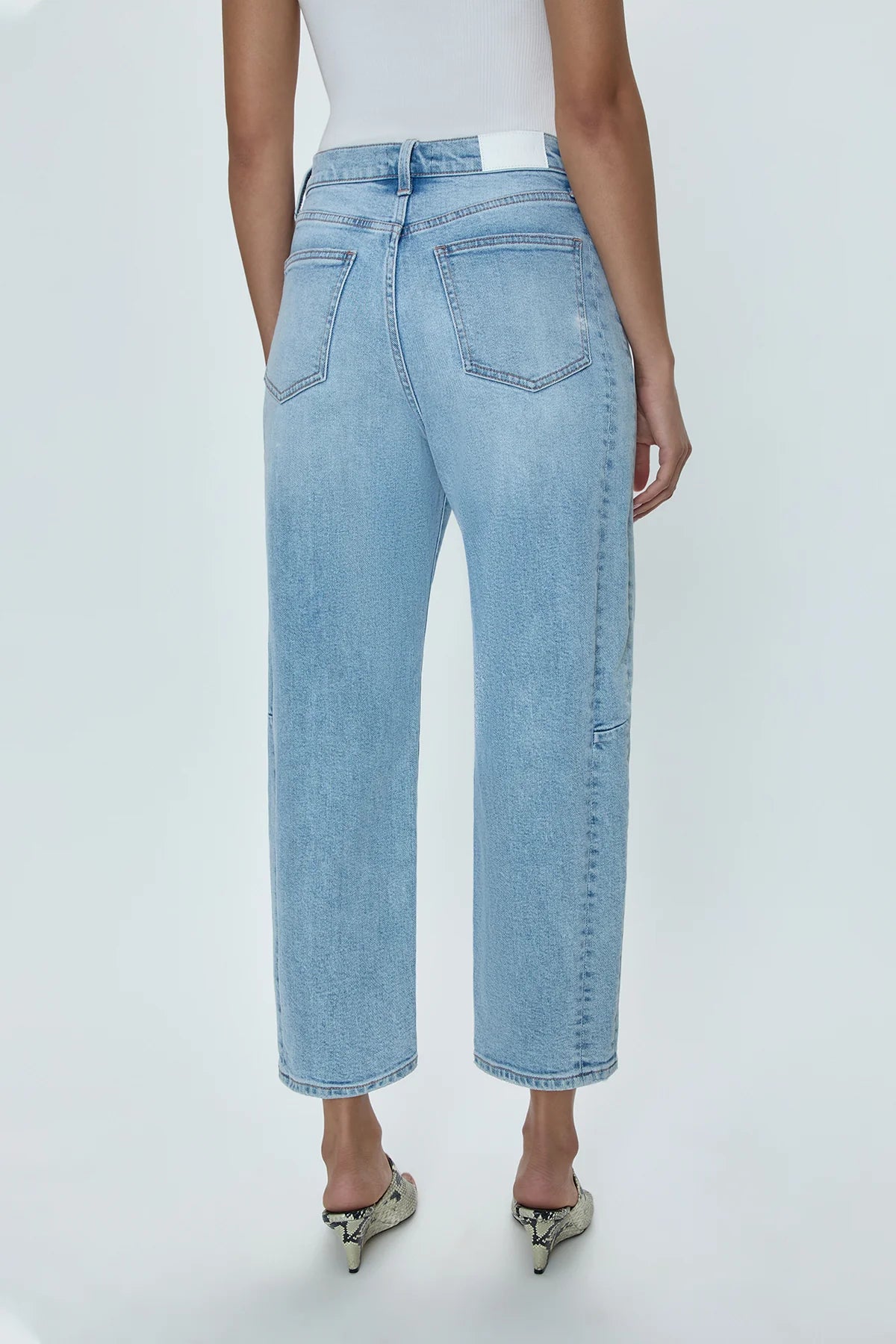 Women's high rise barrel jeans crafted from comfort stretch, light wash denim.