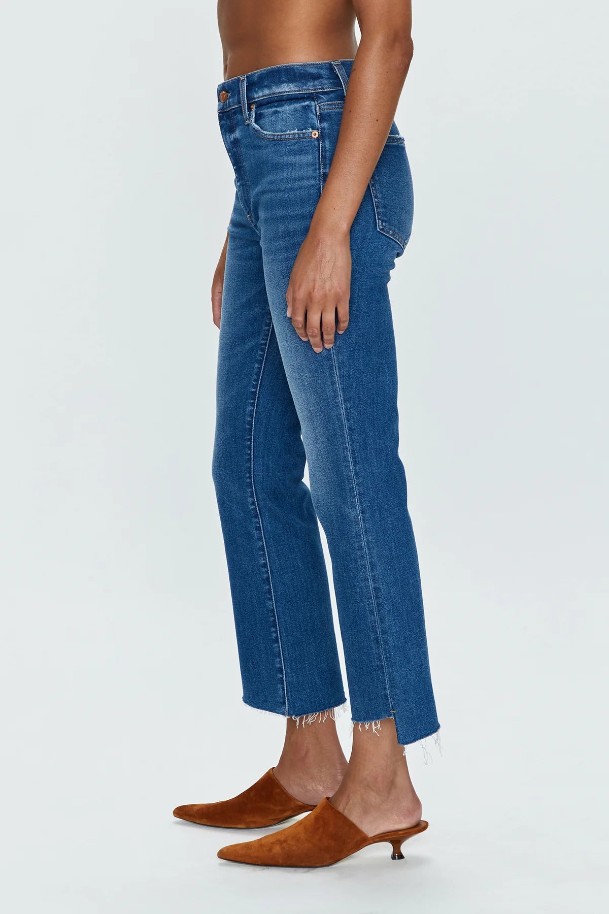 Side view of woman wearing medium wash high rise cropped bootcut jeans by Pistola