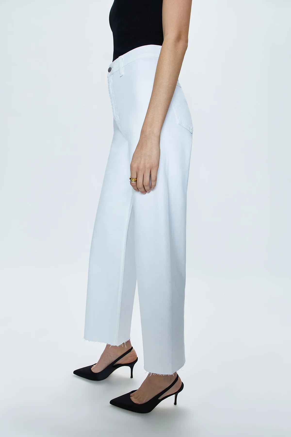 Side view of a woman wearing the white Penny High Rise Wide Leg Crop Jean by Pistola