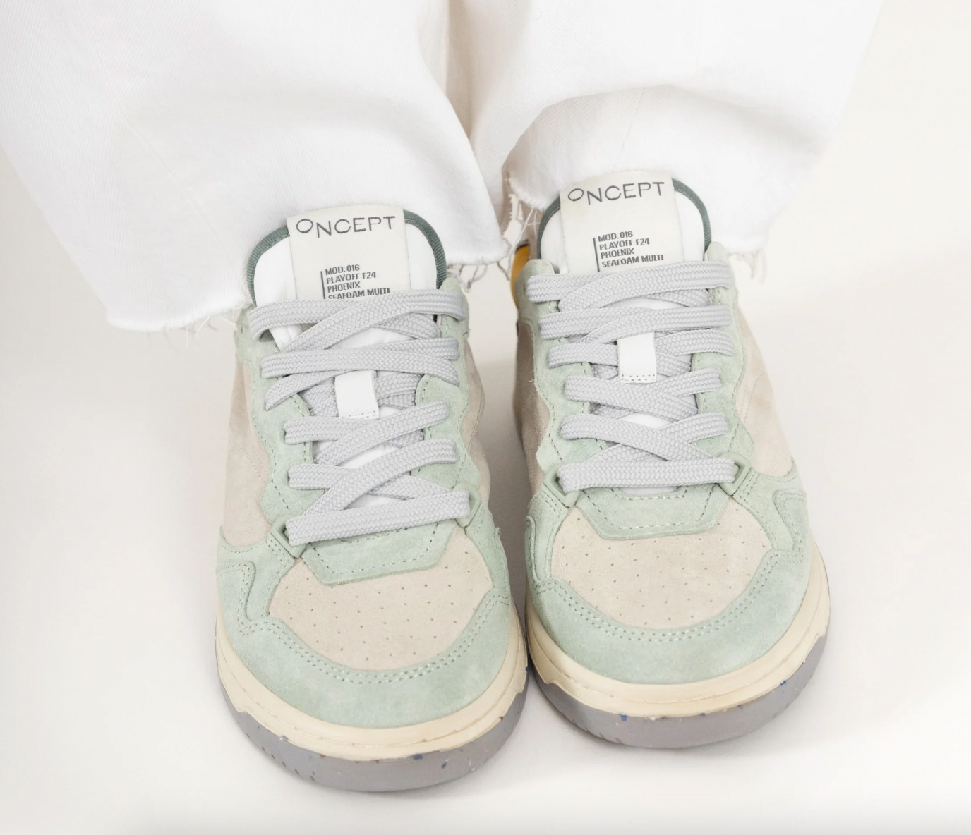 A person wearing the Seafoam Multi Phoenix Sneakers by Oncept