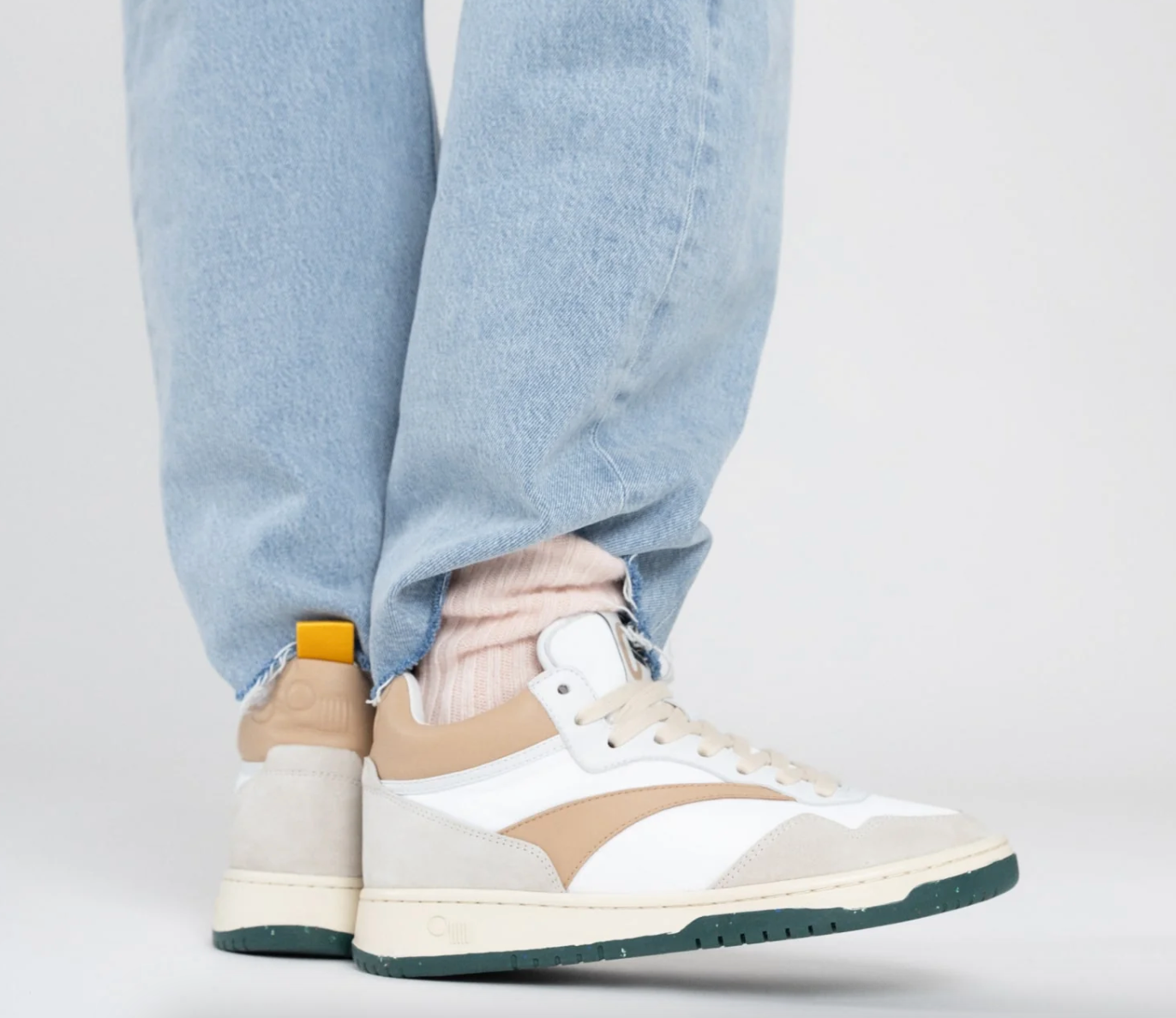 A person wearing the Princeton Mid-Top Sneaker by Oncept