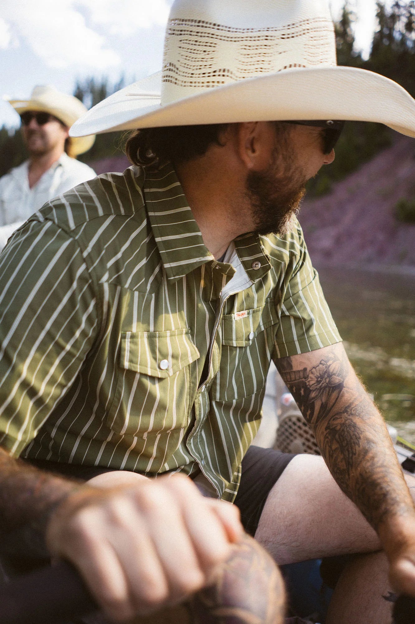 Man on a boat with friends wearing the El Ranchero Short Sleeve Shirt by the brand Seager