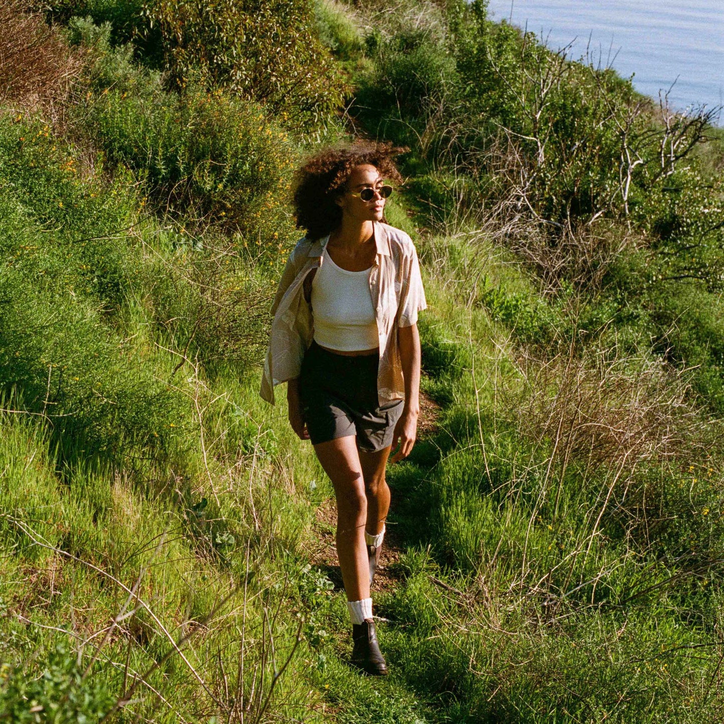 The Roark Women's Bless Up Breathable Stretch Shirt at Harbour Thread is perfect for hot summer days at the beach or on a hike.