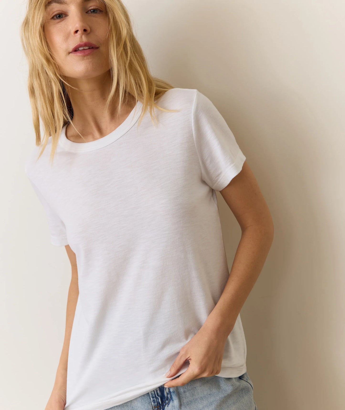 Woman wearing a plain white full length short sleeve t-shirt from Marine Layer