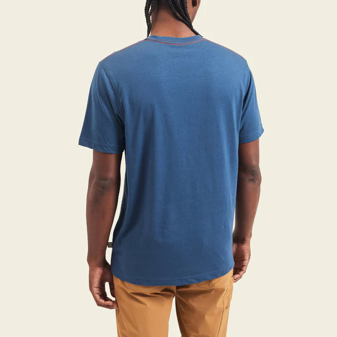 Back view of man wearing a blue Howler Bros short sleeve men's t-shirt