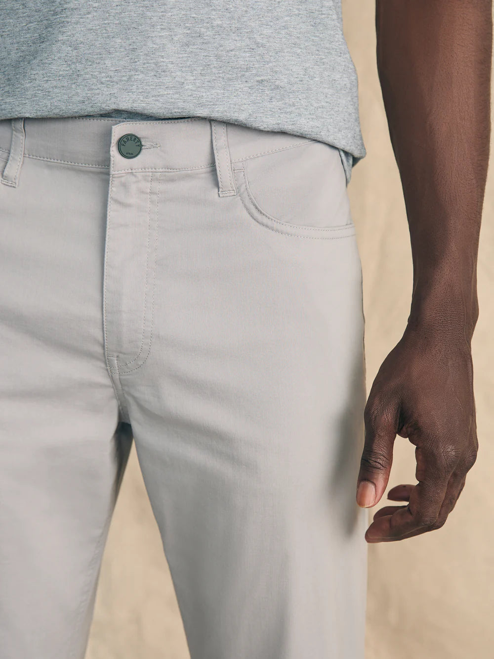 Front design details on the men's Movement 5-Pocket Pant by Faherty, in the color Fossil