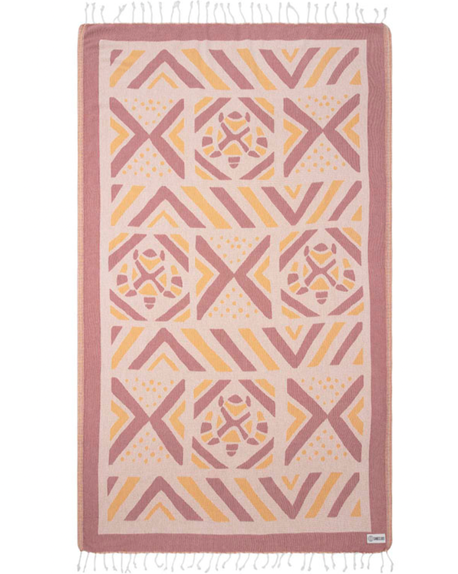 Geometric patterned beach towel with pink and yellow design