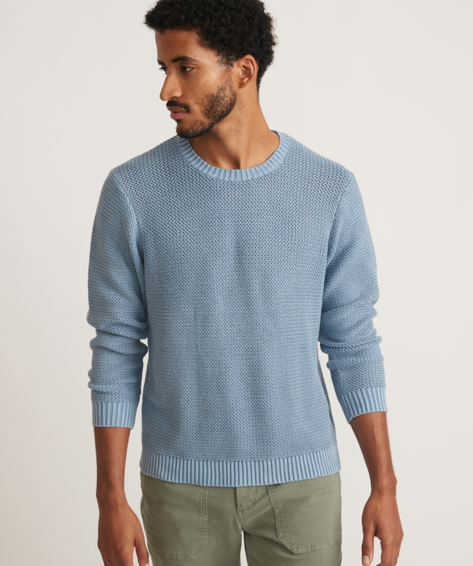 Front view of man wearing a blue garment dye crew sweater from Marine Layer