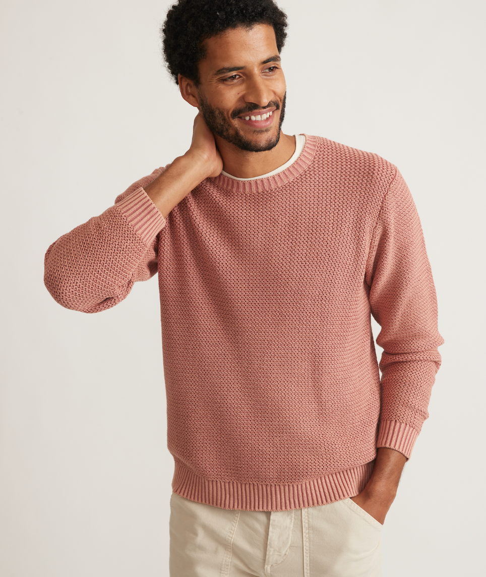 Front view of man wearing a clay color garment dye crew sweater from Marine Layer