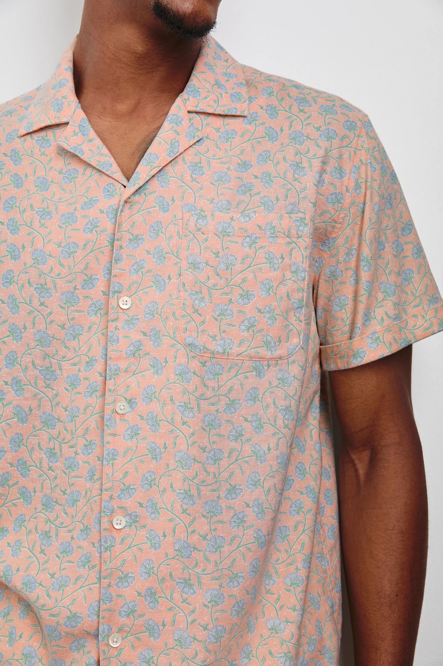 Men's pink short sleeve button down shirt with blue floral print