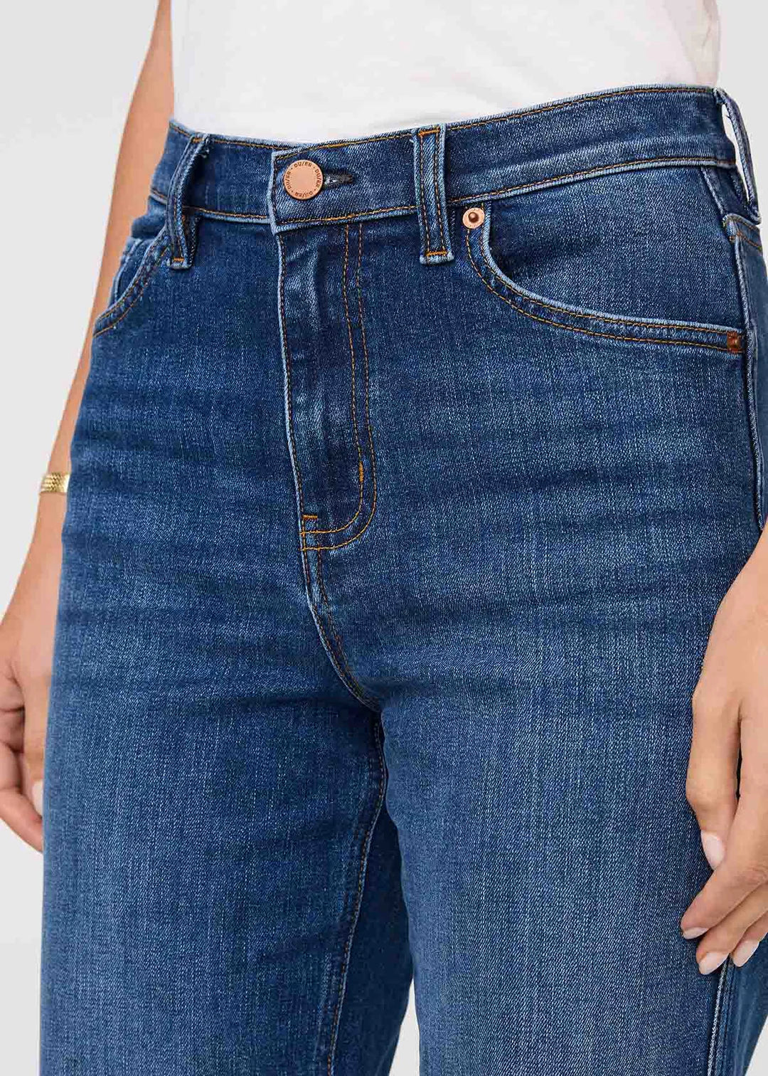Close-up of blue jeans with a white background
