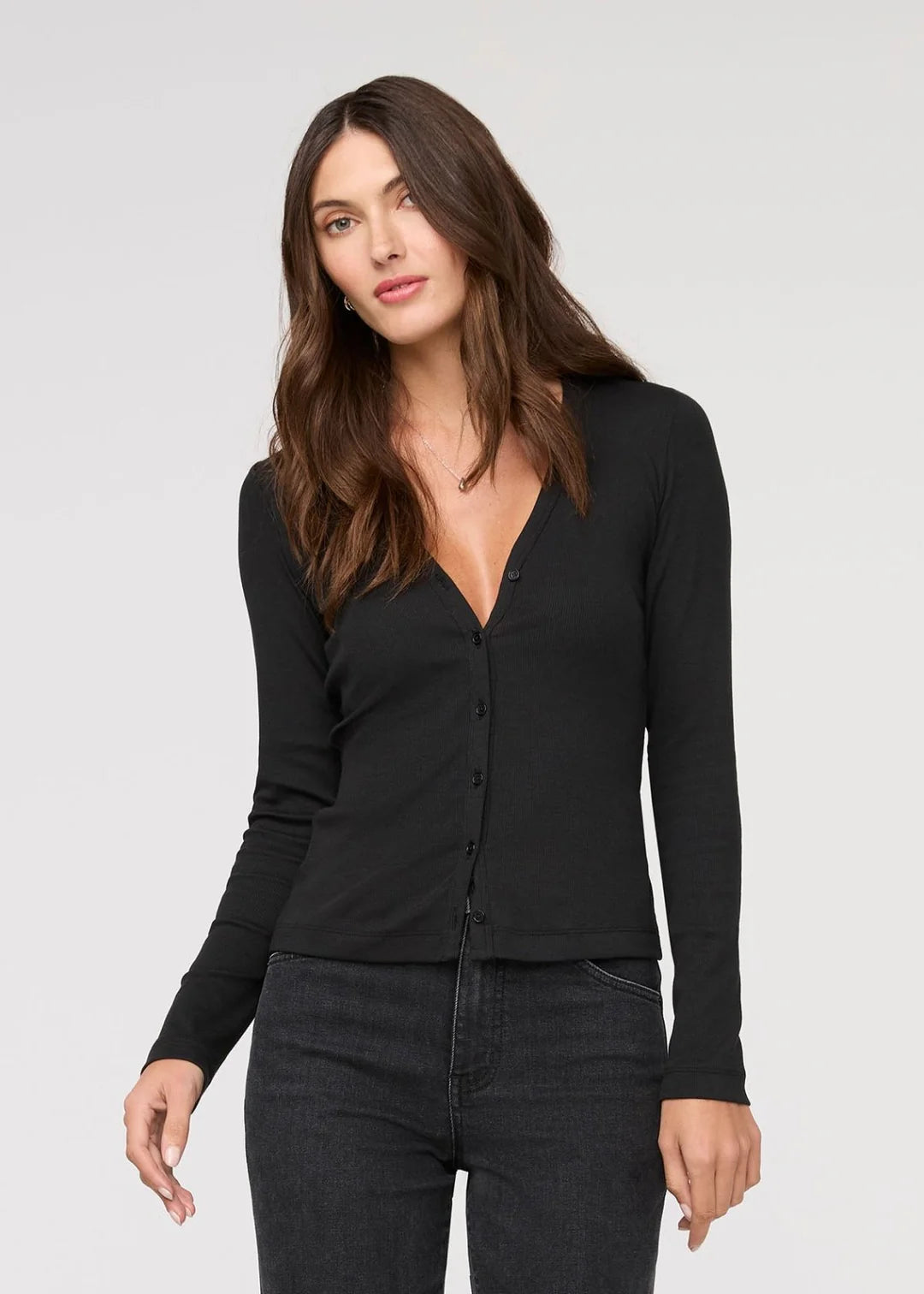 This slim-fitting long sleeve top offers a flattering deep v-neckline and a standard hip-length hem. Find yours at Harbour Thread boutique in Burlington, VT.