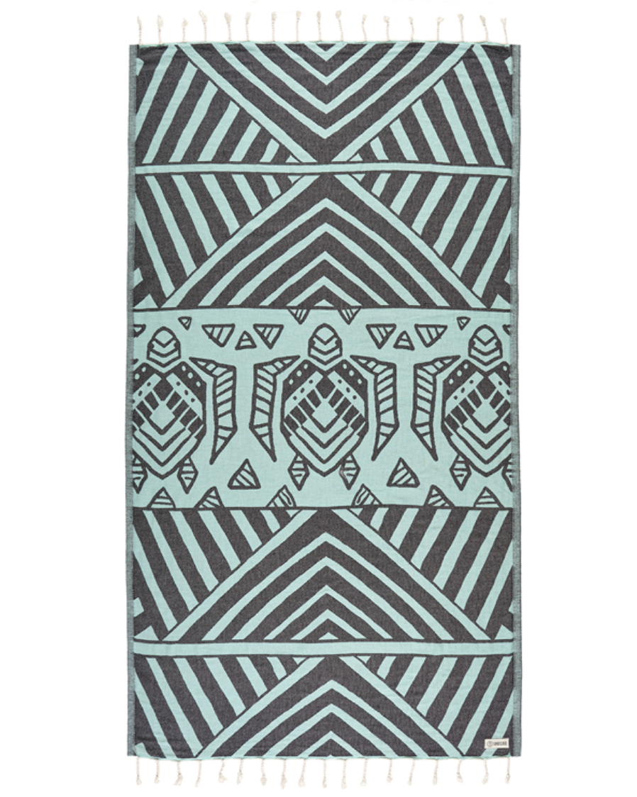 Enjoy your time in the sand with the eco-conscious Sand Cloud Geo Turtle Towel, available at Harbour Thread boutique.
