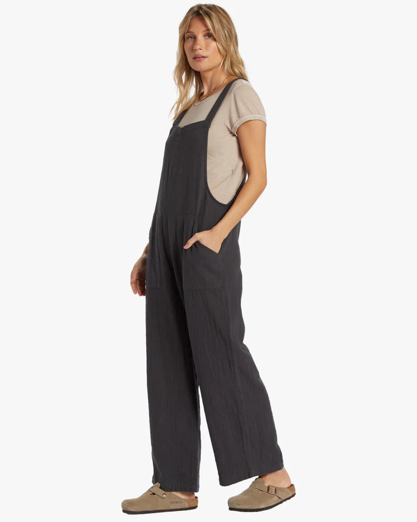 Side view of the Billabong Pacific Time Jumpsuit in the color Black Sands