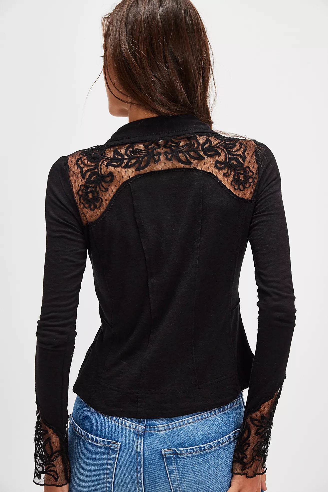 Black long-sleeve top with lace details on a white background