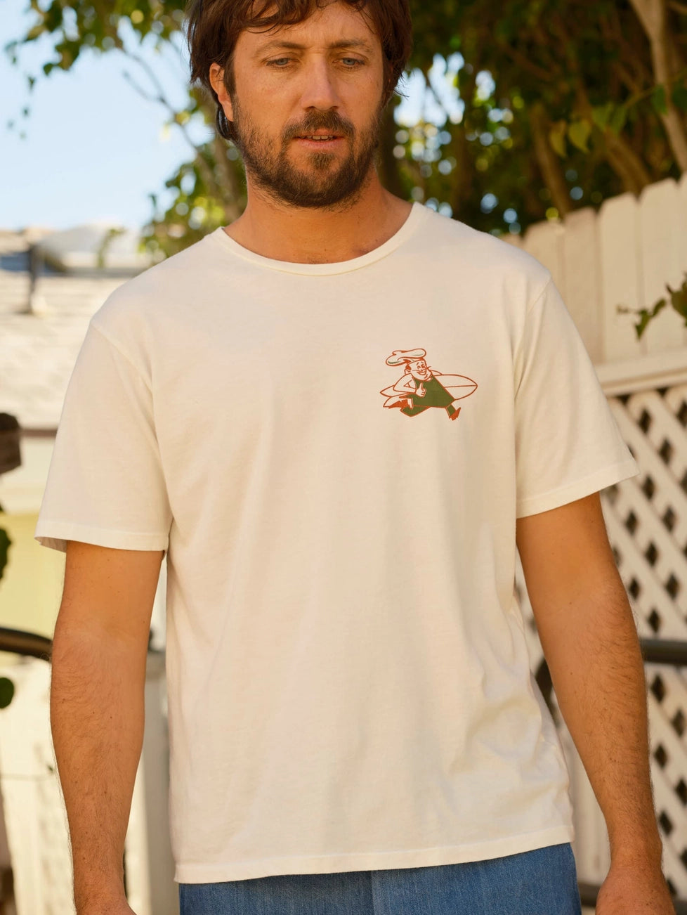 A man wearing the Mollusk Pretty Fresh Tee in the color Antique White