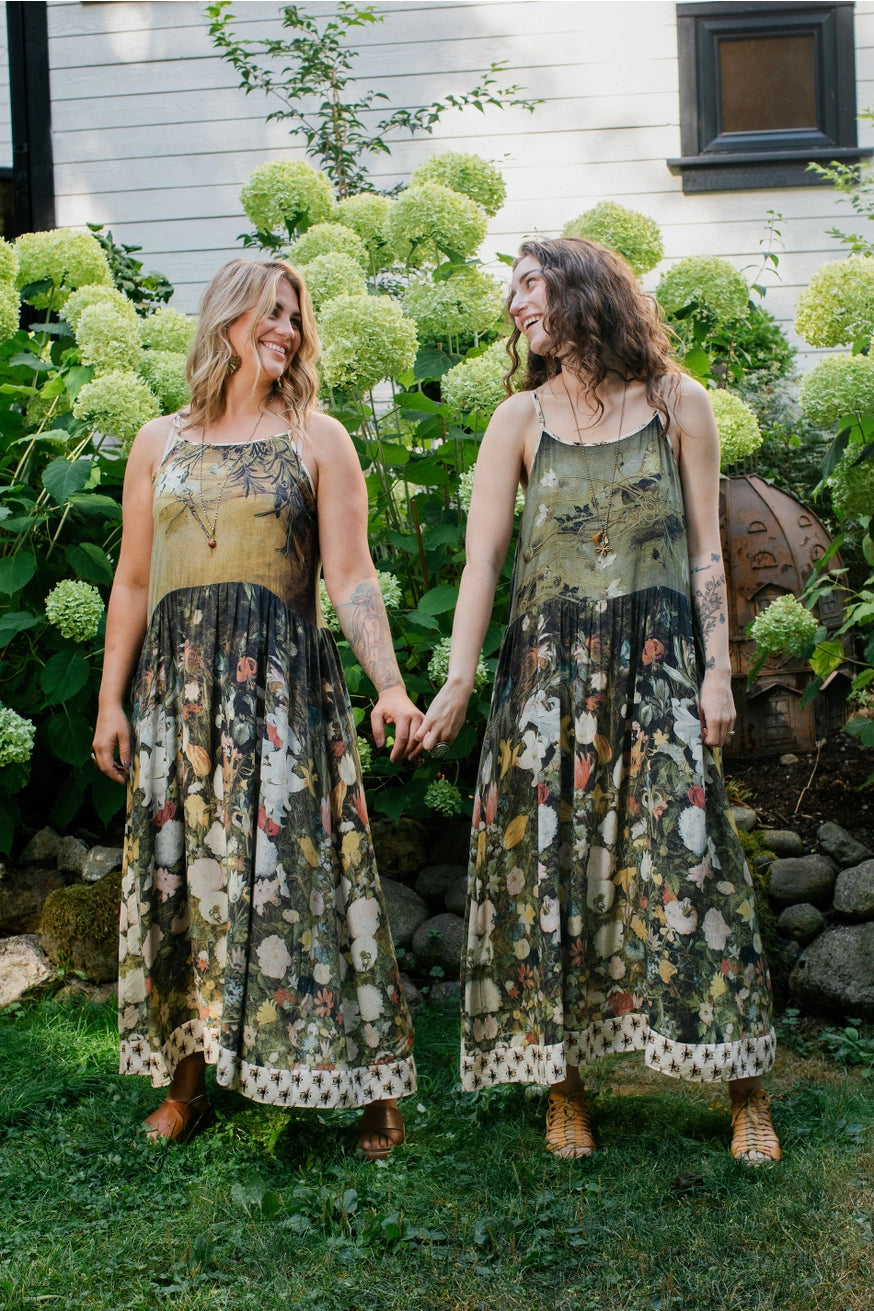 Two woman wearing the I Dream in Flowers Bohéme Slip Dress with Bees by Market of Stars, each showing the reverse side wear