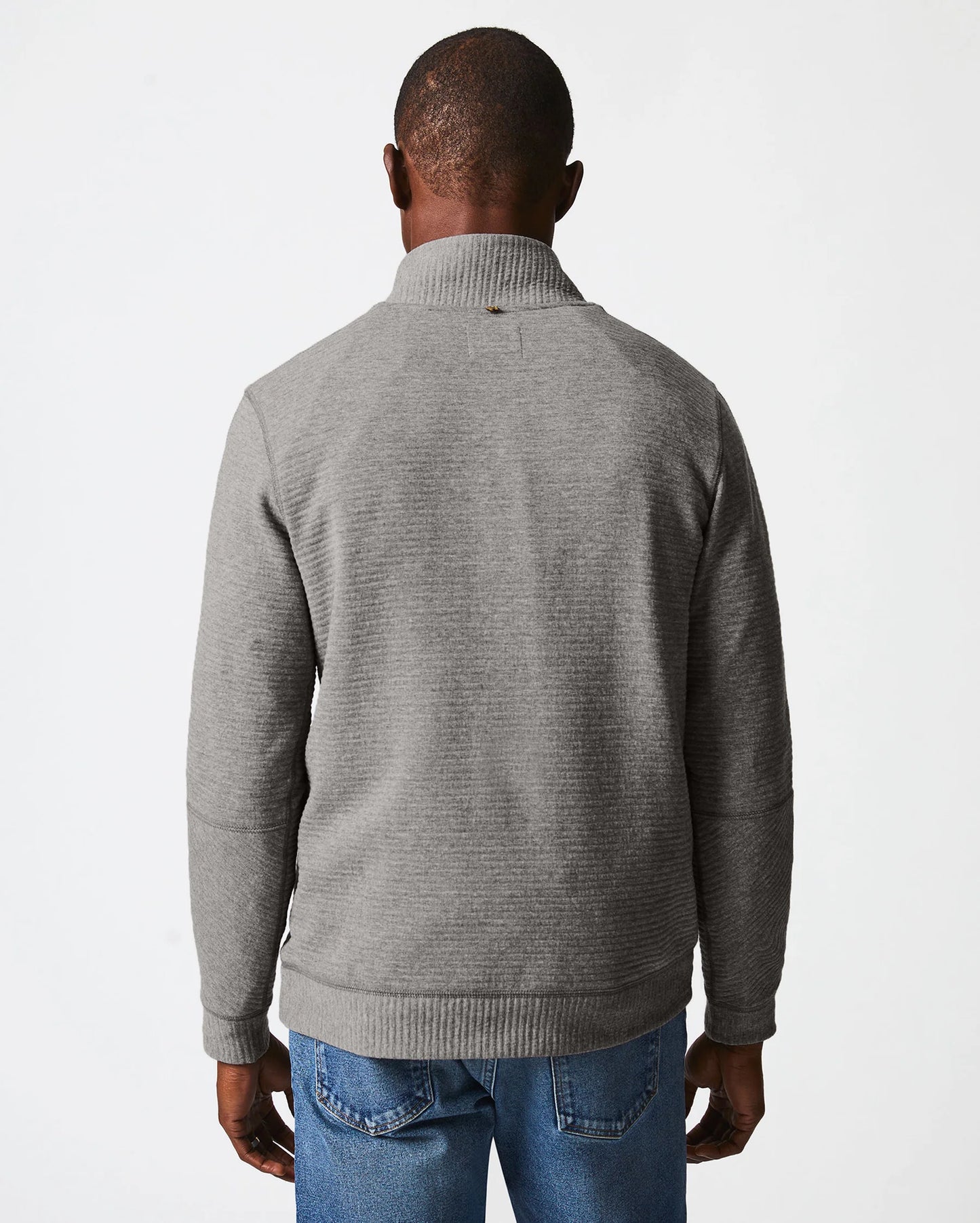 Back view of man wearing a grey quilted half zip pullover sweater by Billy Reid