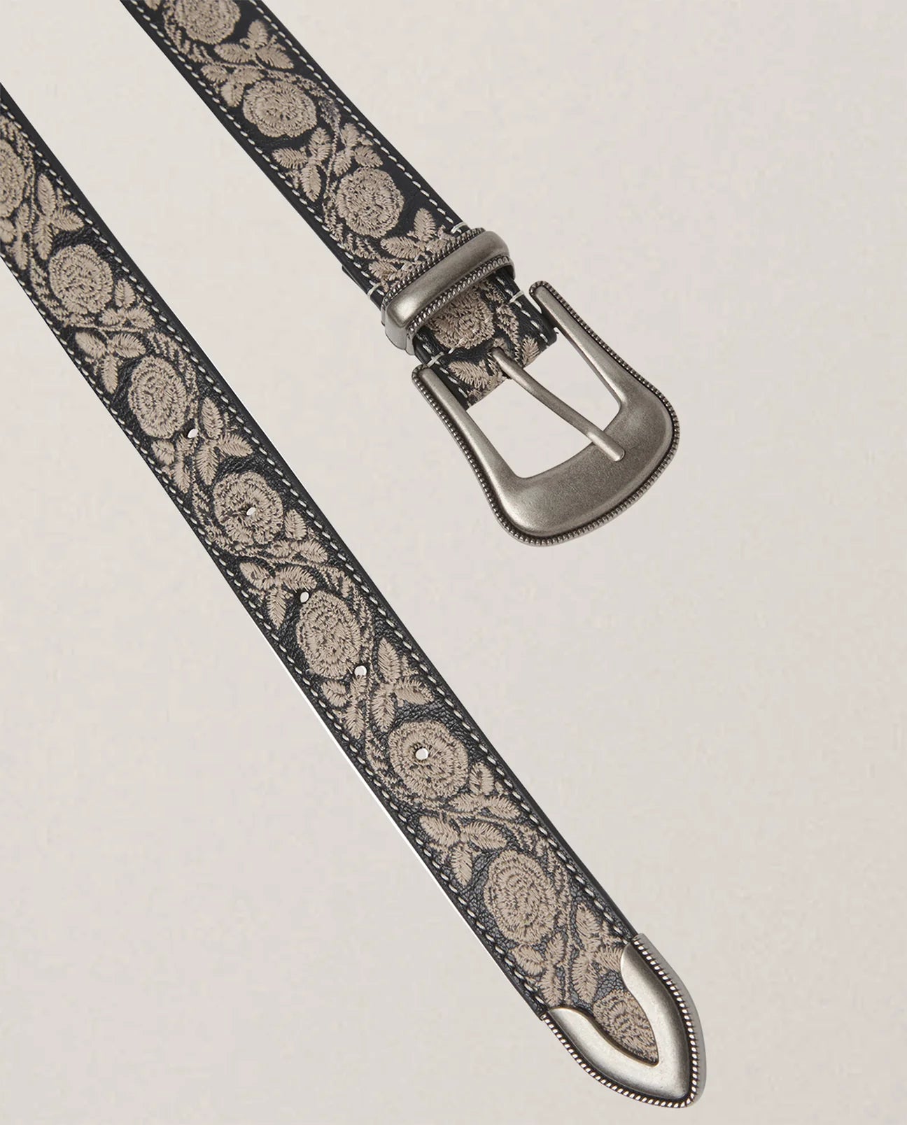 Black leather belt with silver buckle and artisanal detail
