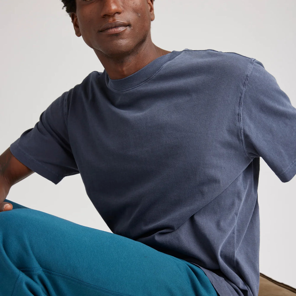 
                      
                        A man wearing the Relaxed Short Sleeve Men's Tee by Richer Poorer in the color Blue Steel
                      
                    