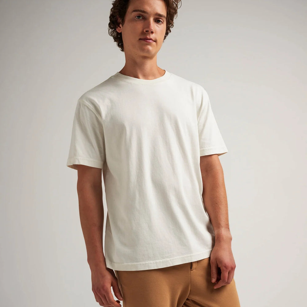 
                      
                        A man wearing the Relaxed Short Sleeve Men's Tee by Richer Poorer in the color Bone
                      
                    