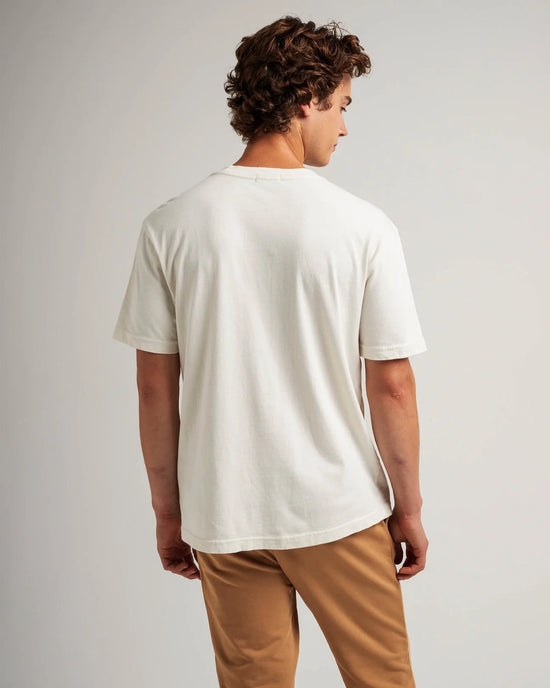 back view of man wearing a white short sleeve t-shirt