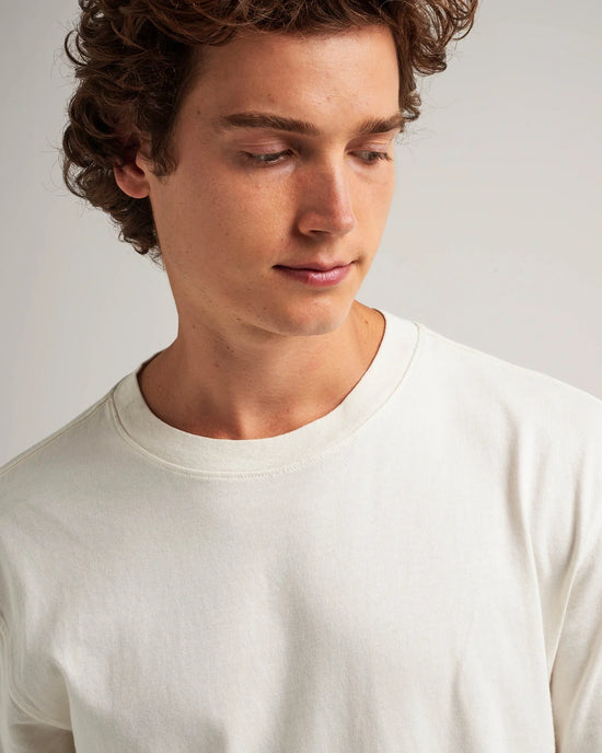 Close up view of man wearing a white short sleeve t-shirt
