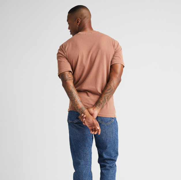 
                      
                        Back view of a man wearing the Relaxed Short Sleeve Men's Tee by Richer Poorer in the color Latte
                      
                    