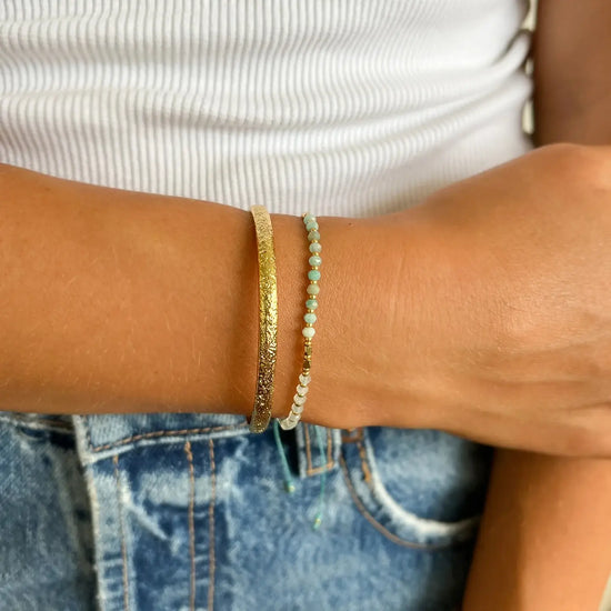 Person wearing the Pia Crystal Beaded Bracelet by Arms of Eve with another bracelet