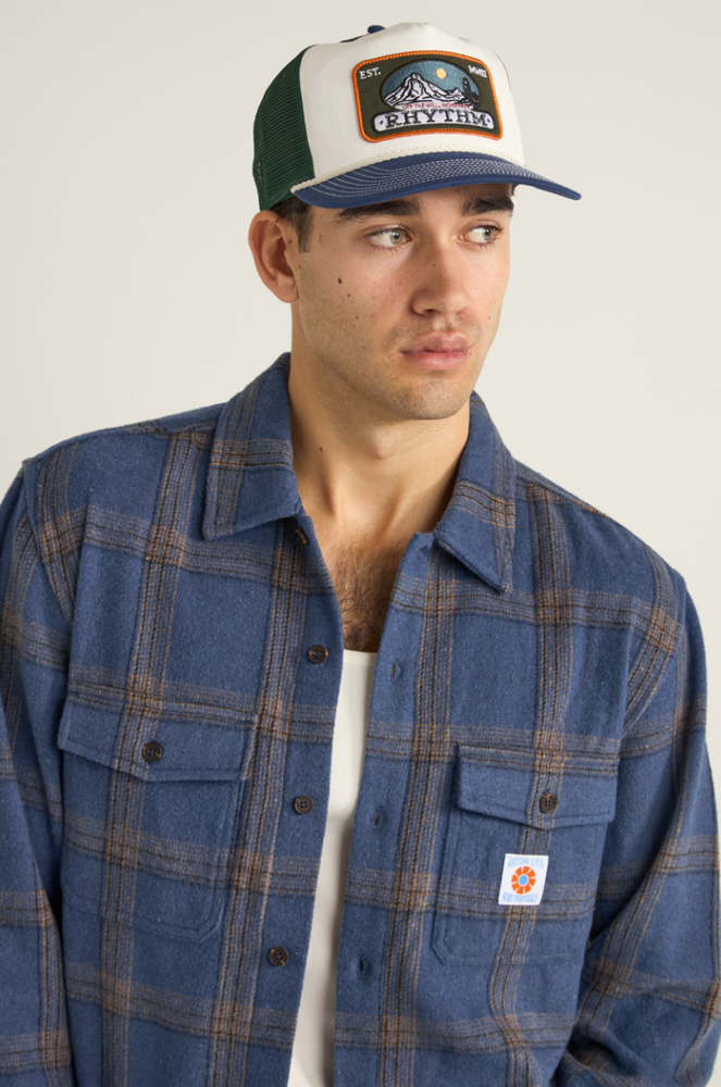 
                      
                        The Blue and Green Horizon Trucker Cap from Rhythm offers everyday style 
                      
                    