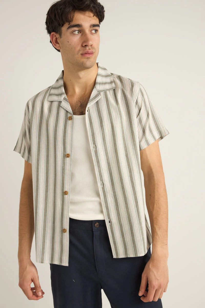 Blending style and function the Vacation Stripe Short Sleeve Shirt by Rhythm is a versatile option for warm-weather days. Now available at Harbour Thread!