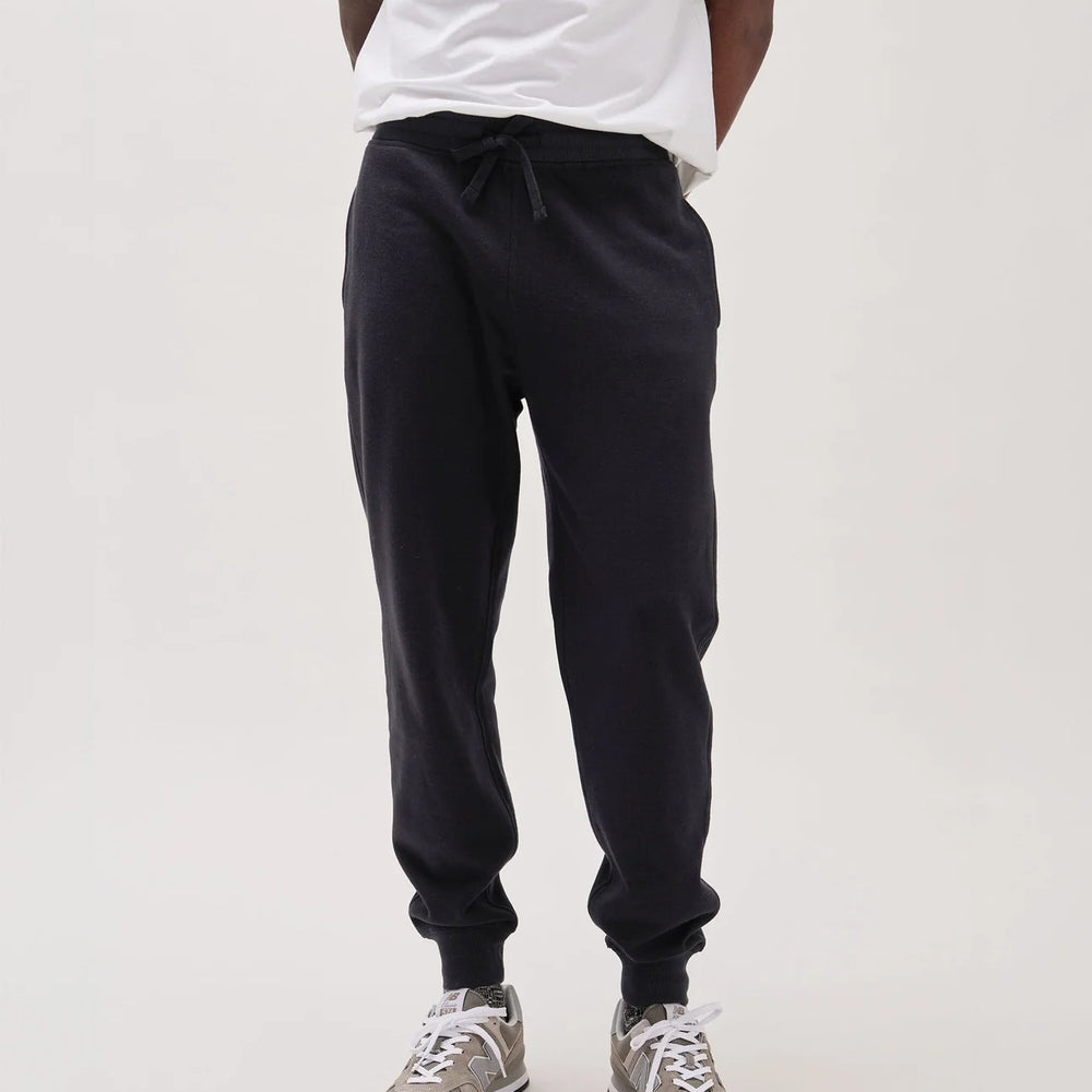 Front view of the men's black recycled fleece tapered sweatpants by Richer Poorer