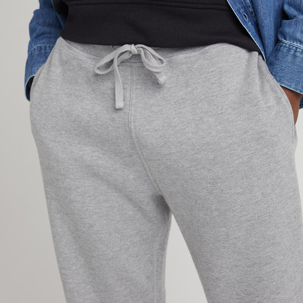 
                      
                        Close up front drawstring closure view of model wearing recycled fleece tapered sweatpant in color heather grey. 
                      
                    