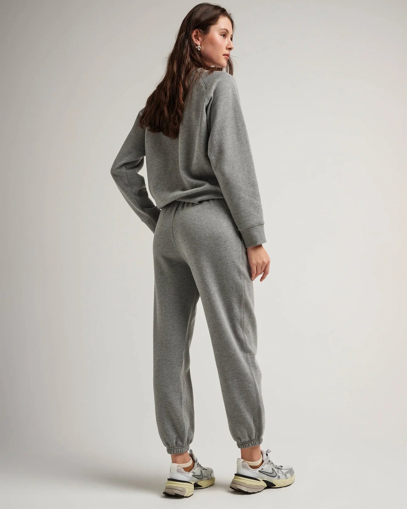 back view of model wearing recycled fleece classic sweatpant in color heather grey