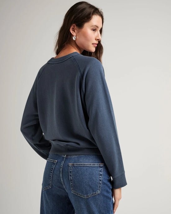 back view of model wearing a crewneck recycled fleece sweatshirt in color mineral moonlit ocean