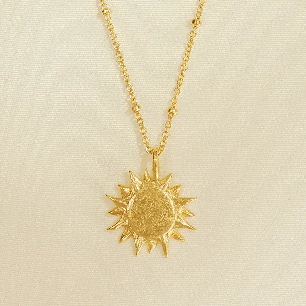 This waterproof gold plated necklace features a small sun pendant to represent guidance and inspiration. 